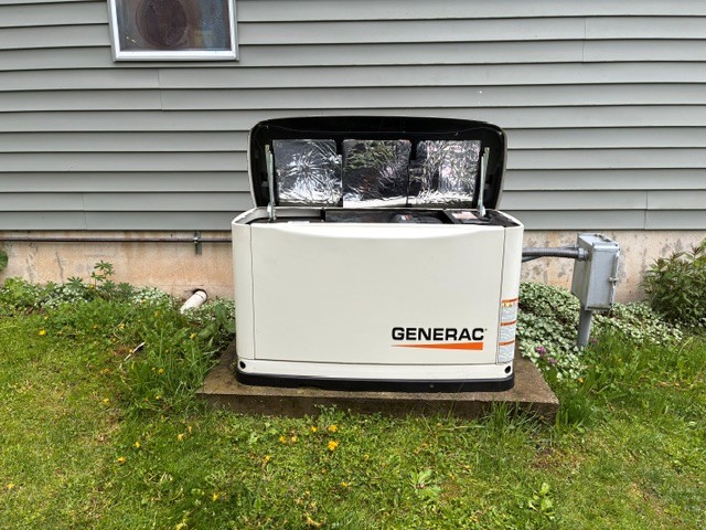 Completed Generac standby generator installation beside a home