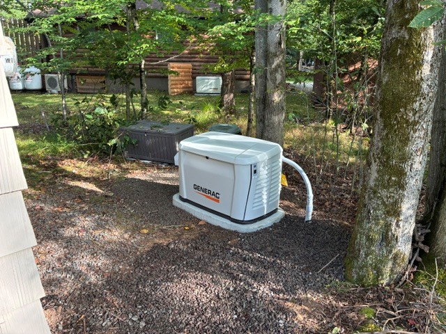 Generac standby generator installed on a wooded Pocono property