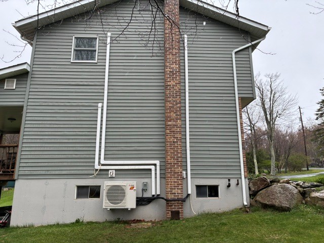 Ductless mini-split system electrical hookup on home exterior
