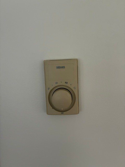 Old worn thermostat before replacement